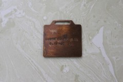 AS FOUND, BRONZE WATCH FOB FROM ALLIS CHALMERS DUNMIRE EQUIPMENT CO. EL PASO, IL