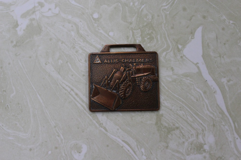 AS FOUND, BRONZE WATCH FOB FROM ALLIS CHALMERS DUNMIRE EQUIPMENT CO. EL PASO, IL